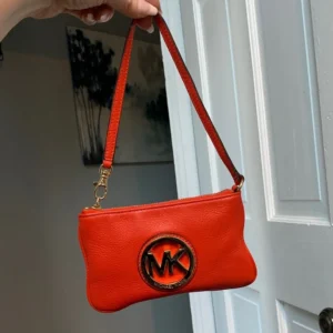 Authentic Michael Kors red-orange leather zippy pouch/wristlet