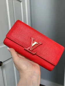 2019 authentic Louis Vuitton Capucines long wallet in bright coral color.