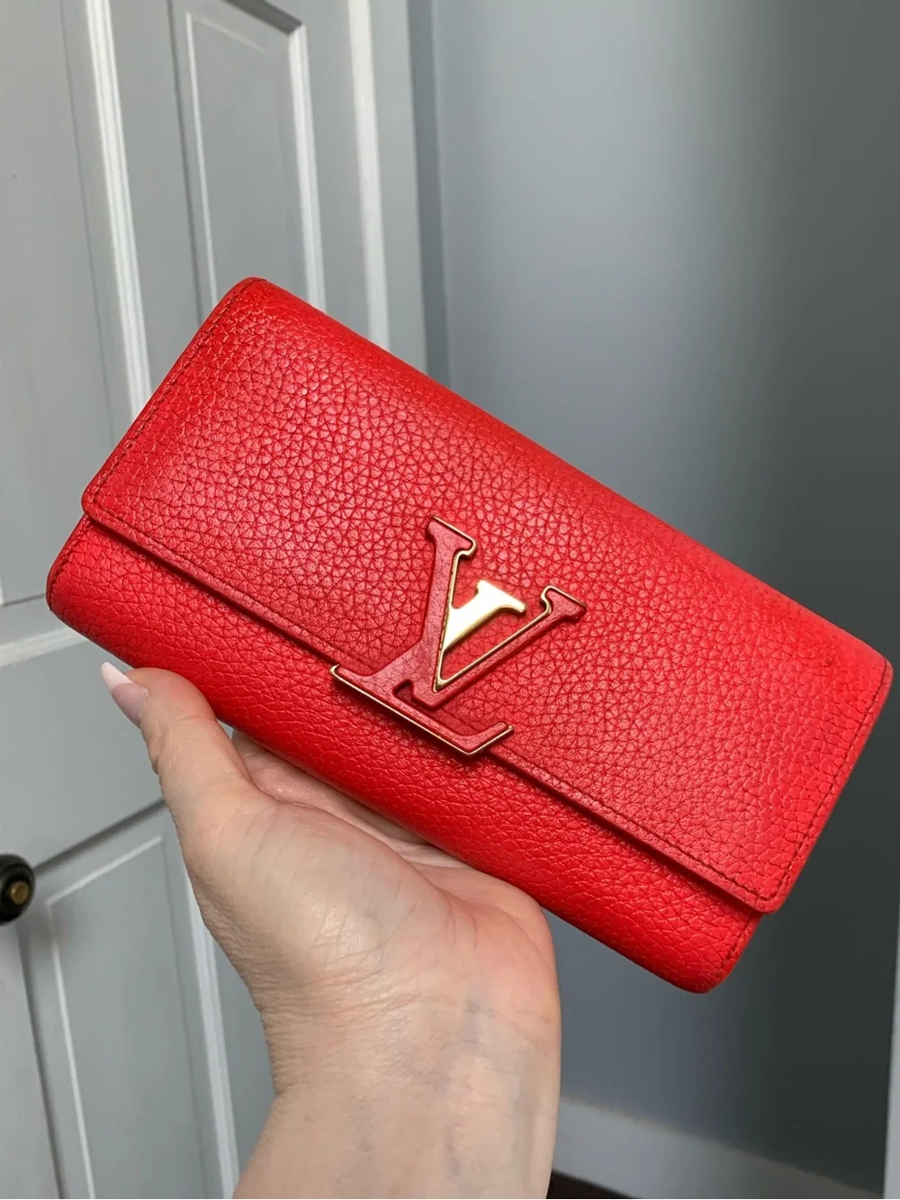 2019 authentic Louis Vuitton Capucines long wallet in bright coral color.